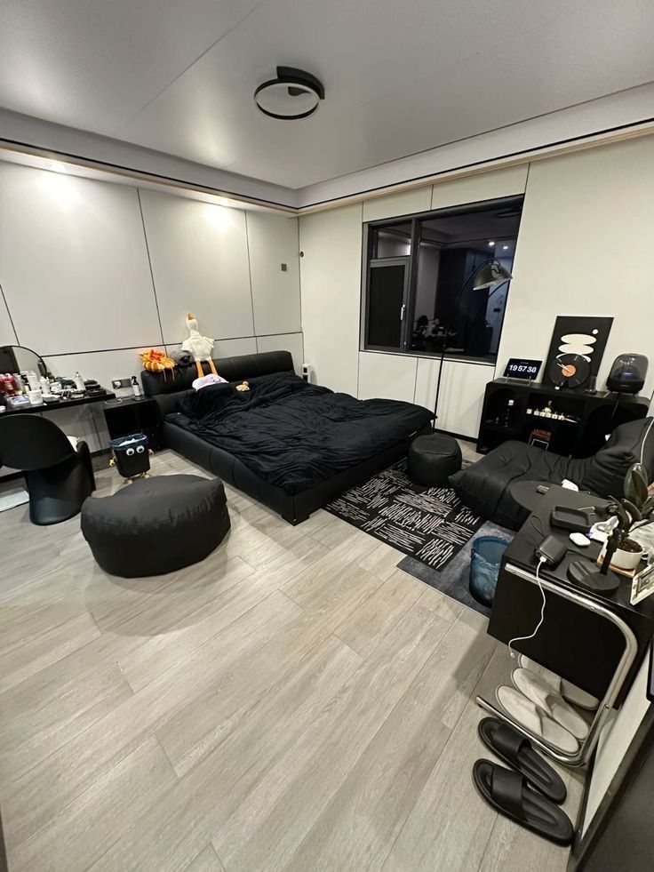 a living room with black furniture and white walls