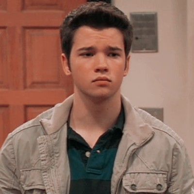 a young man standing in front of a door