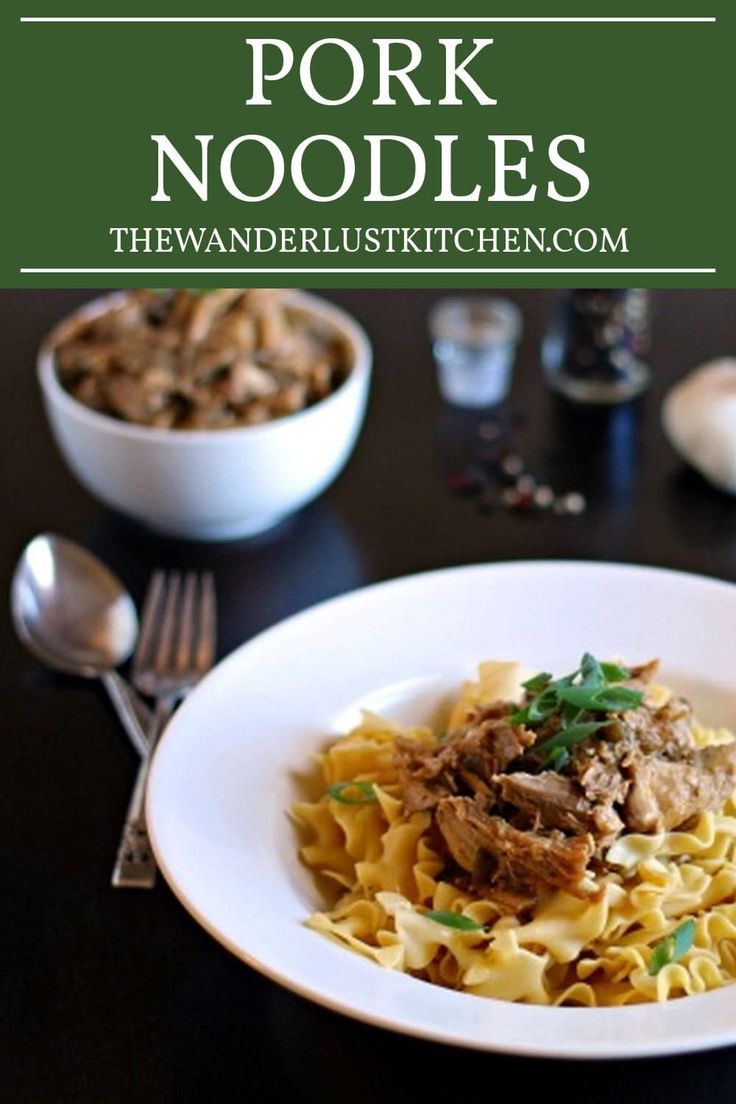 a white plate topped with pasta and meat next to a bowl of mushrooms on a table