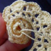 a crocheted object being held in someone's hand