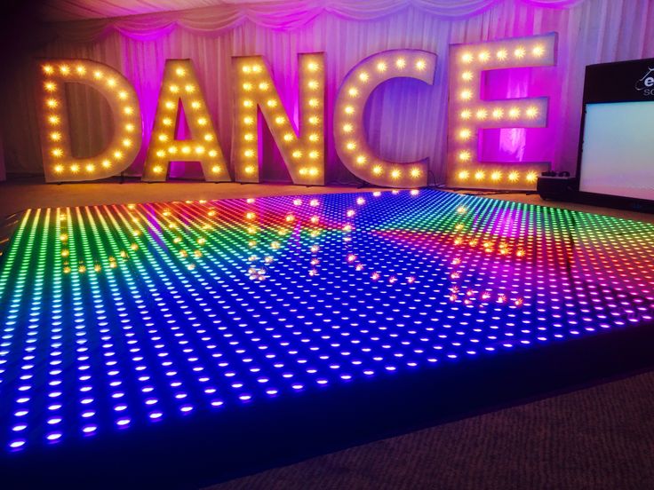 the dance floor is lit up with colorful lights and letters that spell out'dance '