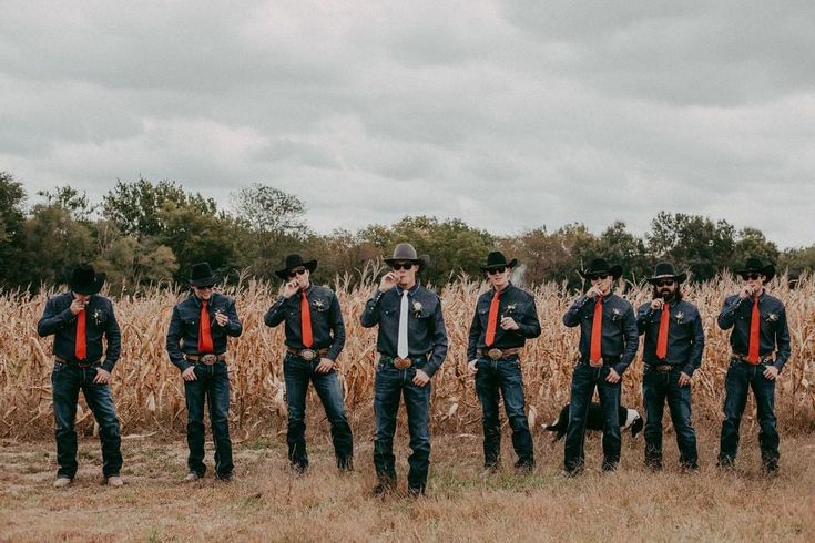 a group of men standing next to each other in a field