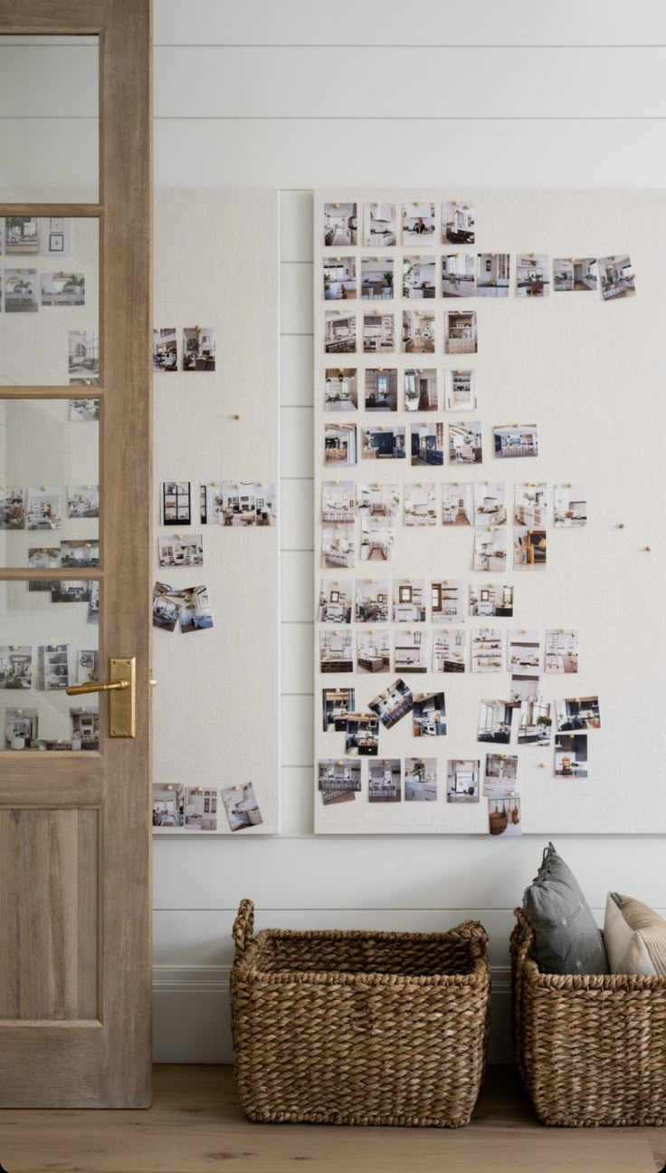 two wicker baskets are sitting in front of a wall with pictures on it and an open door