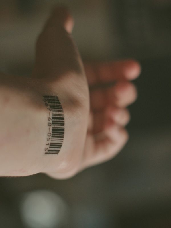 a person's arm with a barcode tattoo on it