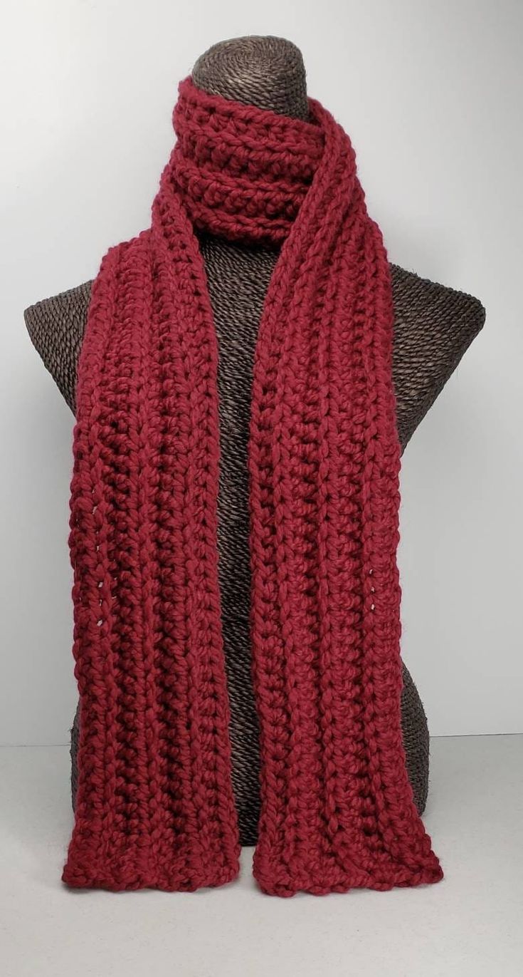 This scarf will keep you cozy and stylish in cold Winter weather. Measures 70 inches long and 5 inches wide. Can be worn multiple ways. Made with a chunky wool blend yarn for warmth and easy care. Machine washable. Crochet Red Scarf, Red Knitted Scarf For Fall, Red Knitted Fall Scarves, Red Knitted Fall Scarf, Red Knitted Scarf For Winter, Cozy Red Scarves For Winter, Red Scarves For Winter Cold Weather, Red Winter Scarves For Cold Weather, Chunky Knit Acrylic Scarves For Cold Weather