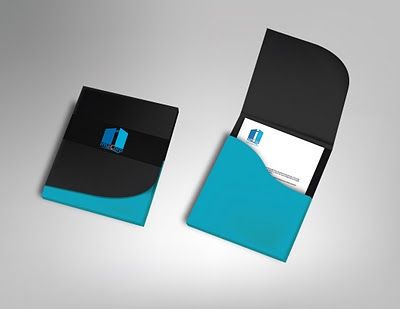 a black and blue business card holder on a gray surface with an envelope in the middle