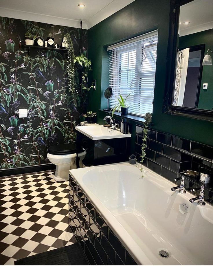 a black and white tiled bathroom with green walls