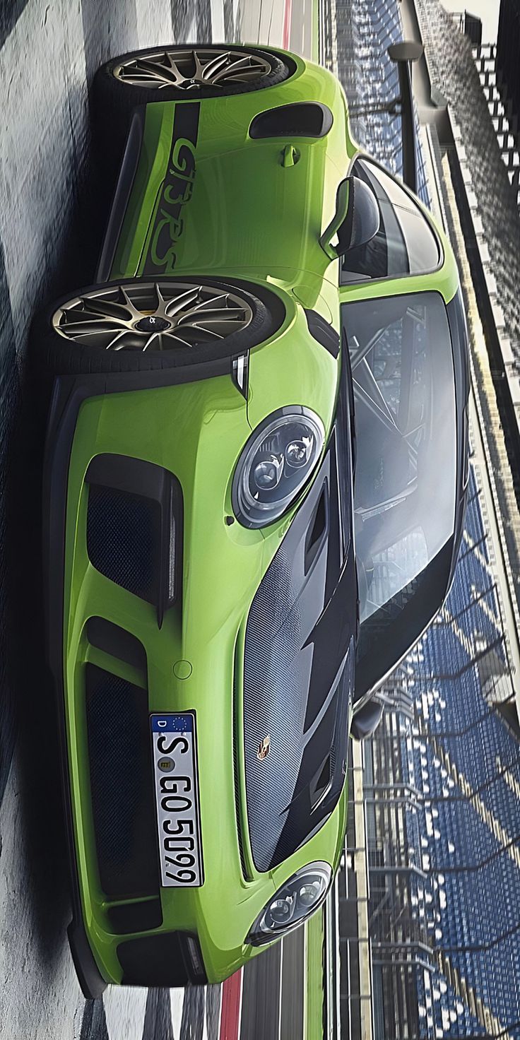 a green sports car parked on the side of a road