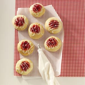 small pastries with icing on a red and white checkered cloth next to an umbrella