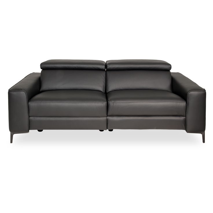 a black leather couch sitting on top of a white floor