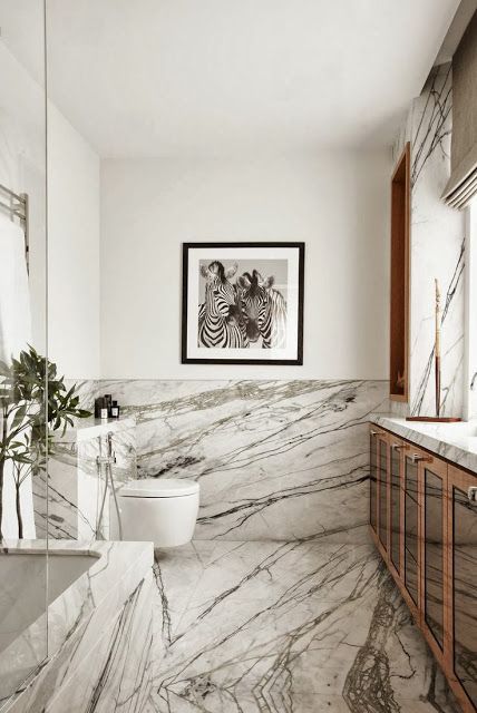 a bathroom with marble walls and flooring