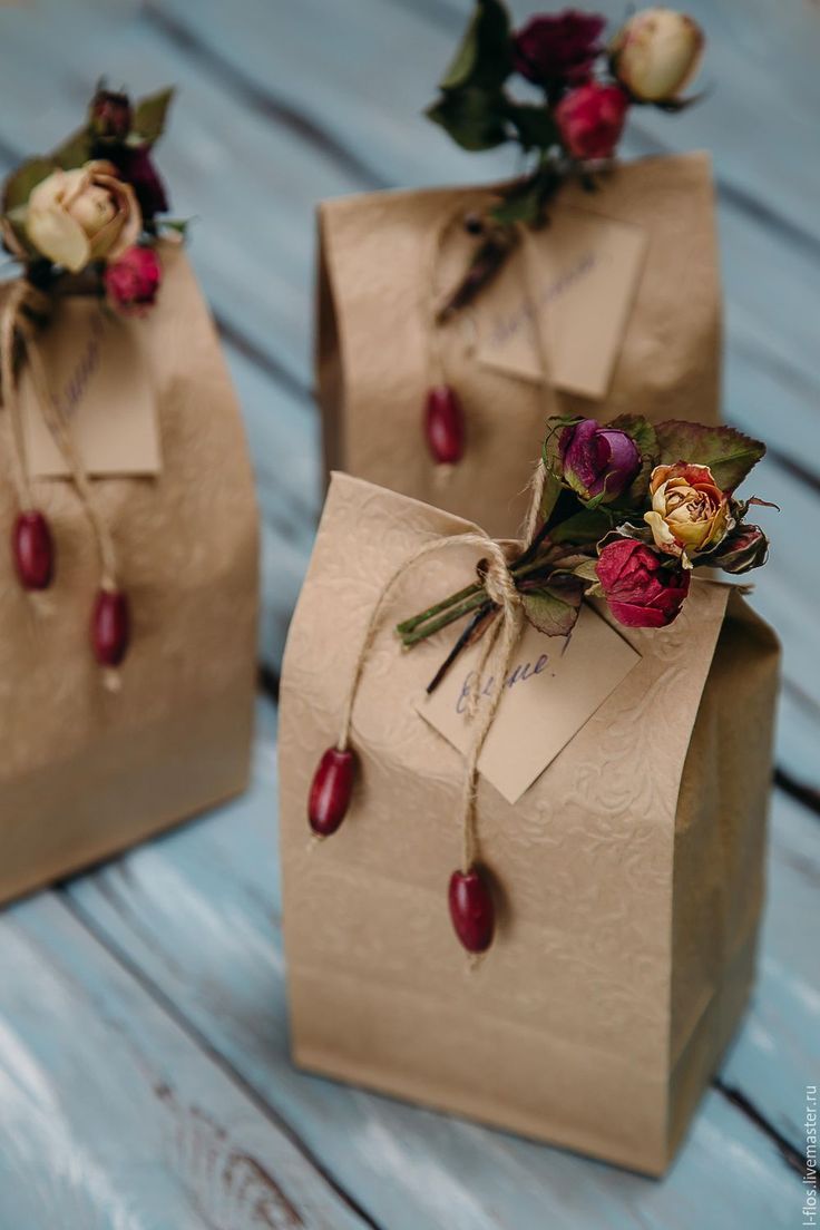 two brown paper bags with flowers on them