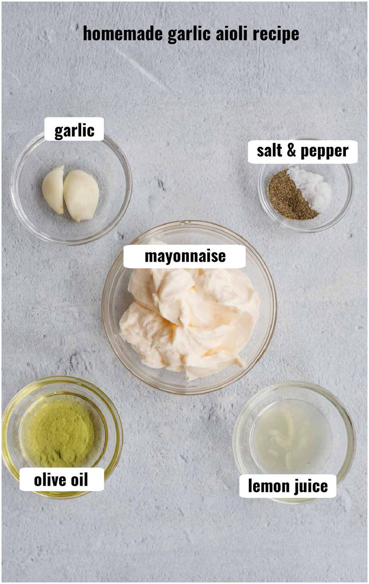 ingredients to make homemade garlic aioli recipe in small glass bowls on a gray background