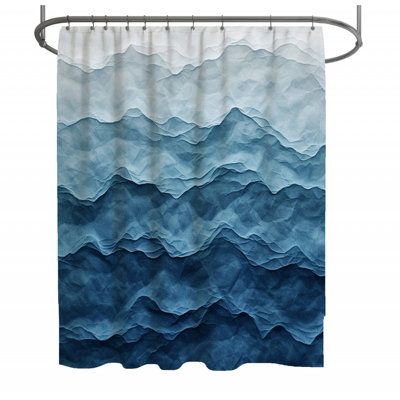 a shower curtain with blue and white waves on the water, in front of a white background