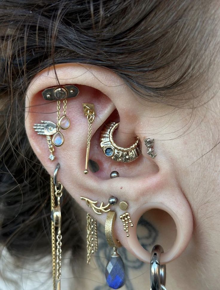 a close up of a person with ear piercings on their ears and behind the ear