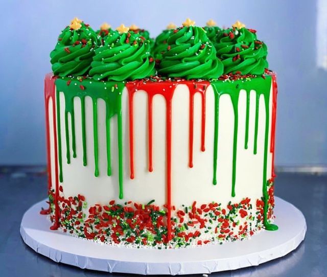 a decorated cake with green frosting and sprinkles