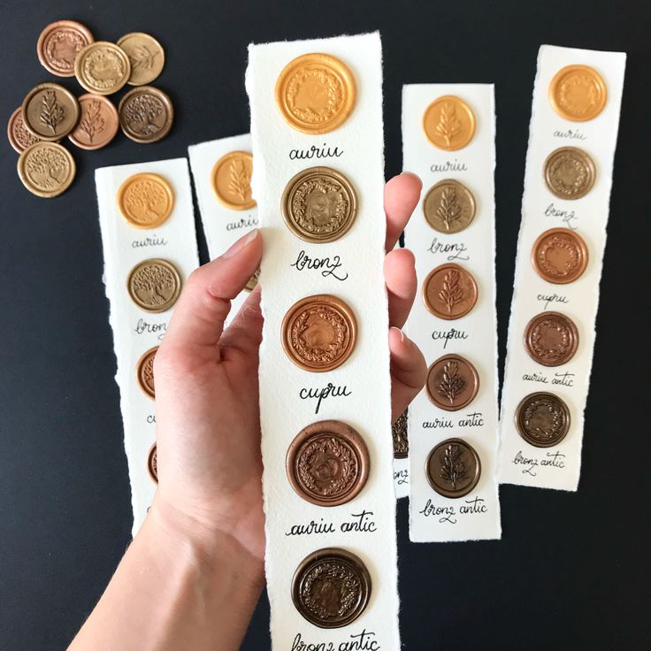 a person is holding some type of money in front of several other types of coins