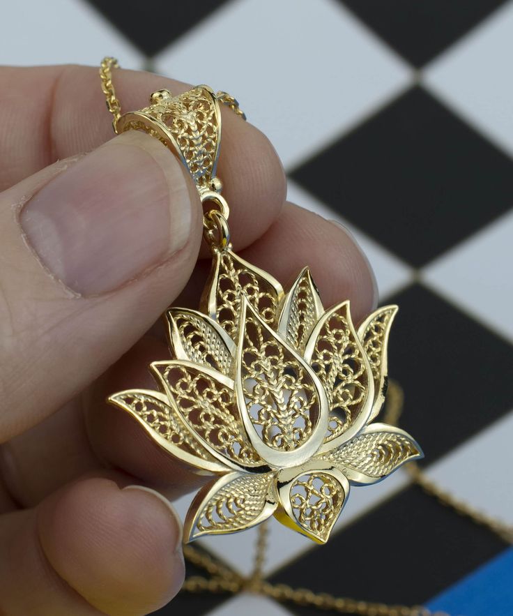 This 14k Gold Plated 925 Sterling Silver handcrafted filigree art lotus flower pendant necklace comes with 20" silver chain option. Beautifully crafted filigree details will catch all eyes on you. It is going to be exact match to your daily wear. It can also be perfect option for valentine`s day, mother`s day or birthday gift for yourself or your loved one. The pendant height is 1.70" / 45.00 mm and the width is 1.20" / 30.50 mm. The optional sterling silver chain is 18.00"+2.00" / 50 cm with ex Lotus Jewelry Design, Filigree Pendant Jewelry As Gift, Filigree Jewelry Gold, Traditional Filigree Flower Pendant Necklace, Gold Filigree Flower Pendant Necklace, Filigree Flower-shaped Necklace For Gift, Spiritual Filigree Flower Pendant Necklace, Lotus Flower Pendant, Flower Women