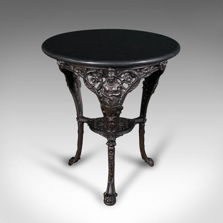 an ornately decorated table with black marble top