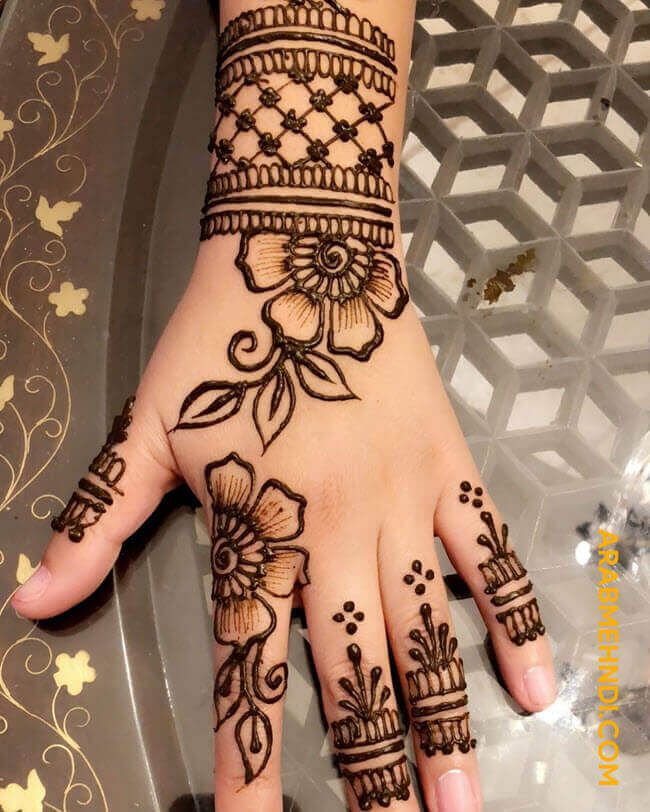 henna tattoo on the palm of a woman's hand with flowers and leaves