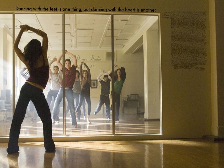 a group of people standing in front of a glass wall with the words dance class written on it