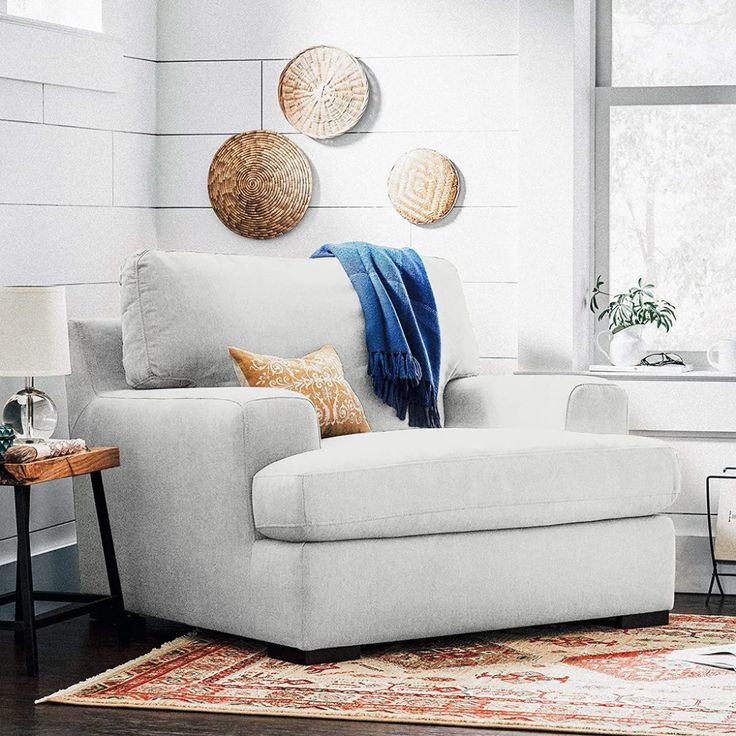 a living room filled with furniture and decor on top of a hard wood floored floor