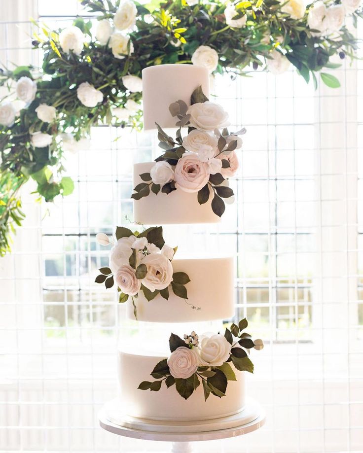 a three tiered white cake with flowers on it