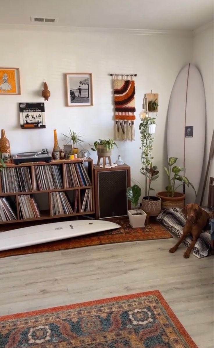 a living room filled with furniture and a surfboard