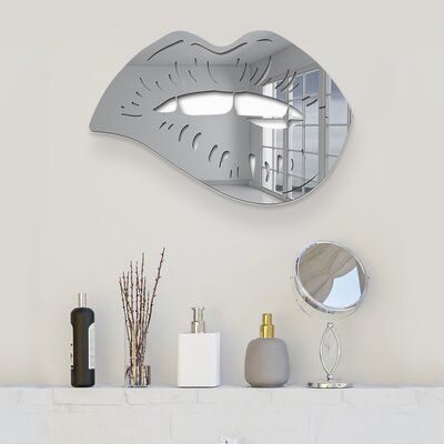 a mirror that is on the wall above a fireplace