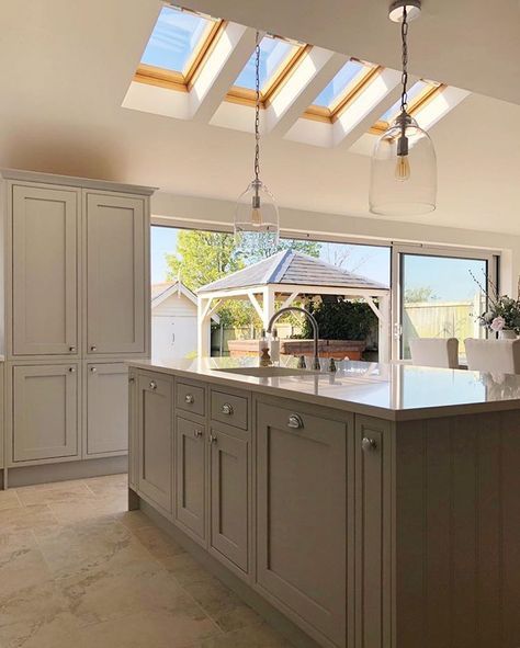 a large kitchen with an island and skylights