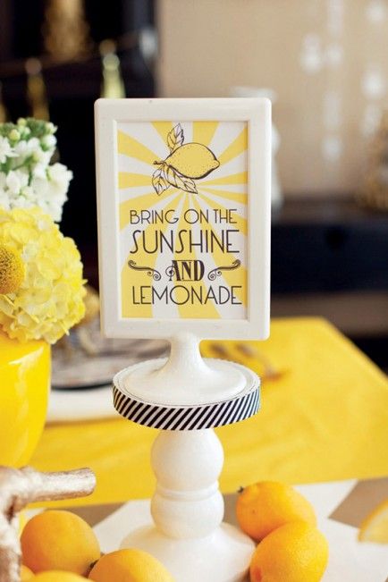 there is a lemonade stand with some lemons on the table and a sign that says bring on the sunshine and lemonade