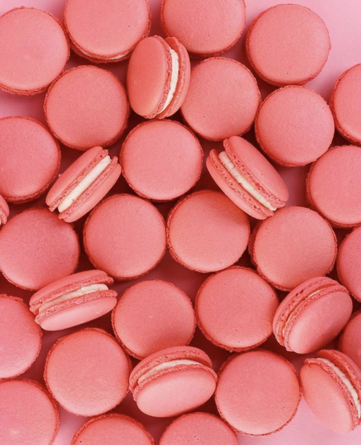 pink macaroons with white frosting on them