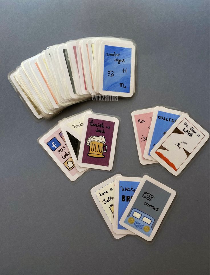 a group of playing cards sitting next to each other on top of a gray table