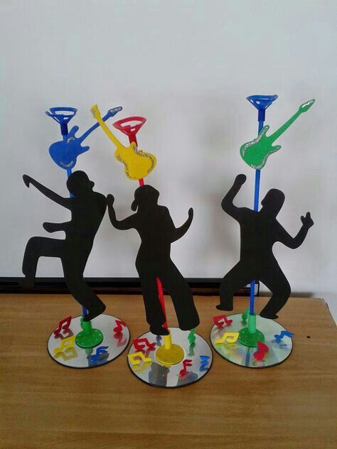 three paper cutouts of people dancing on top of plates with paint splatters