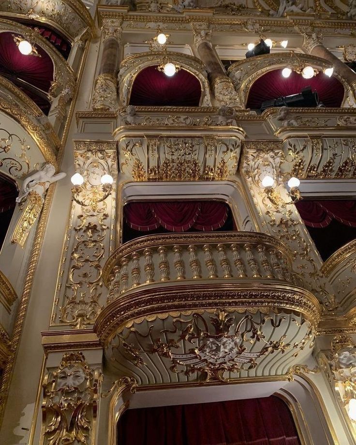 an ornately decorated building with red curtains