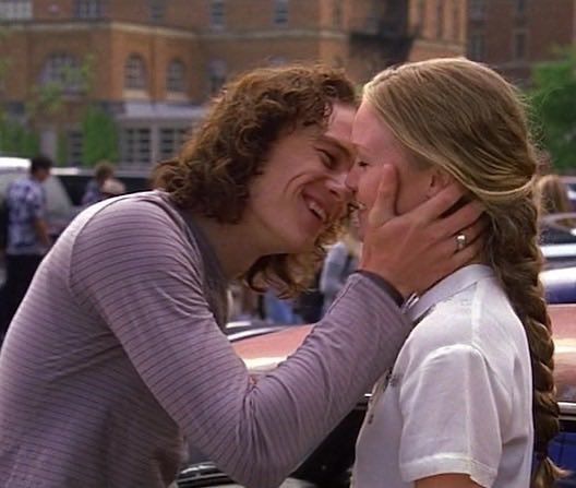 two women kissing each other on the street