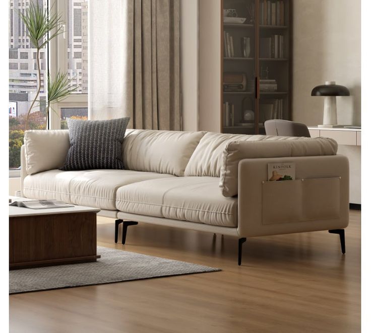 a living room filled with furniture and a book shelf on the wall next to a window