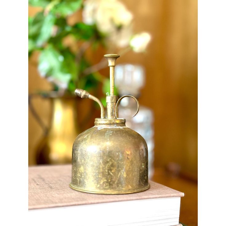 an old brass bell sitting on top of a table