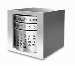 a metal box with a calendar on the front and back side, in silver color