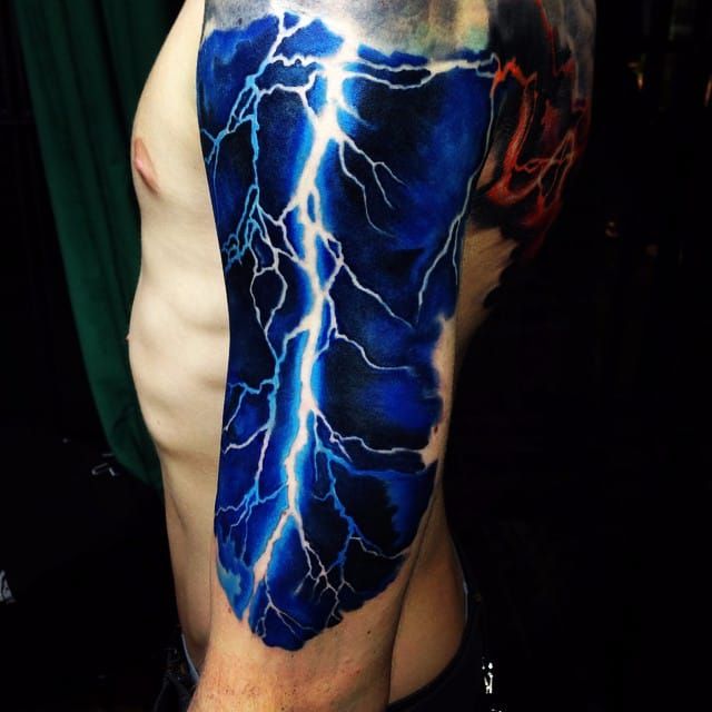 a man with a lightning tattoo on his arm