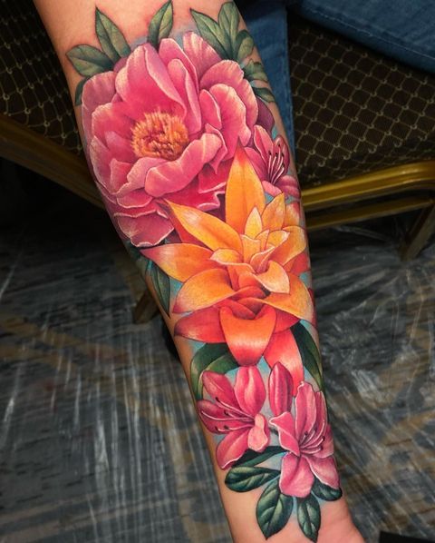 a woman's arm with flowers painted on it