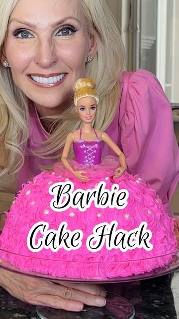 a woman holding a barbie cake with the words barbie cake hackt on it's side