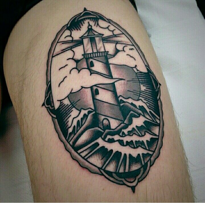 a black and white photo of a lighthouse in the middle of a tattoo on someone's leg