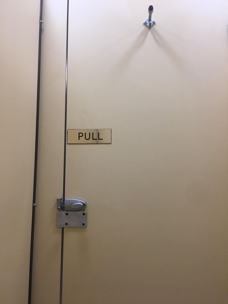 the door is open and there is a pull sign on it