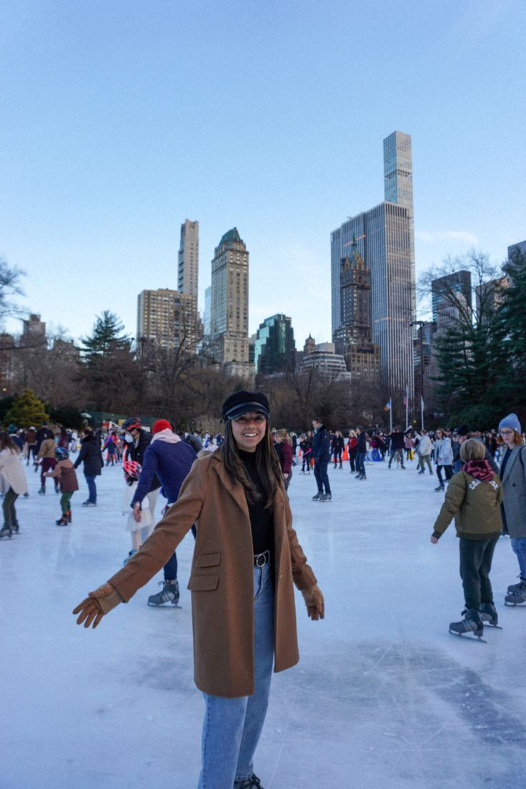 a woman standing on top of an ice rink