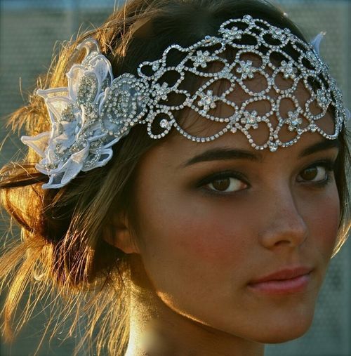 a close up of a woman wearing a head piece