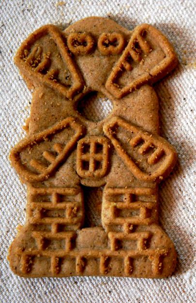 two cookies shaped like people with chinese writing on them, sitting on a tablecloth