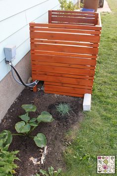 a wooden planter sitting next to a house