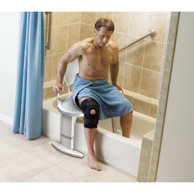 a man sitting on top of a toilet in a bathroom