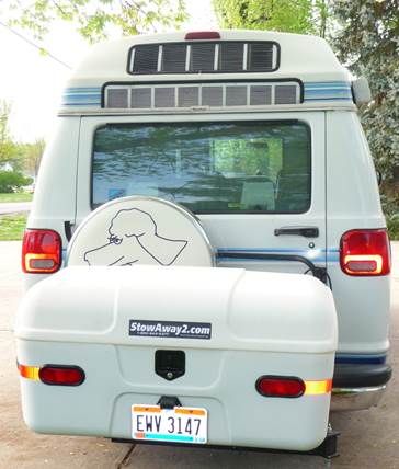 the back end of a van with a dog sticker on it's bumper